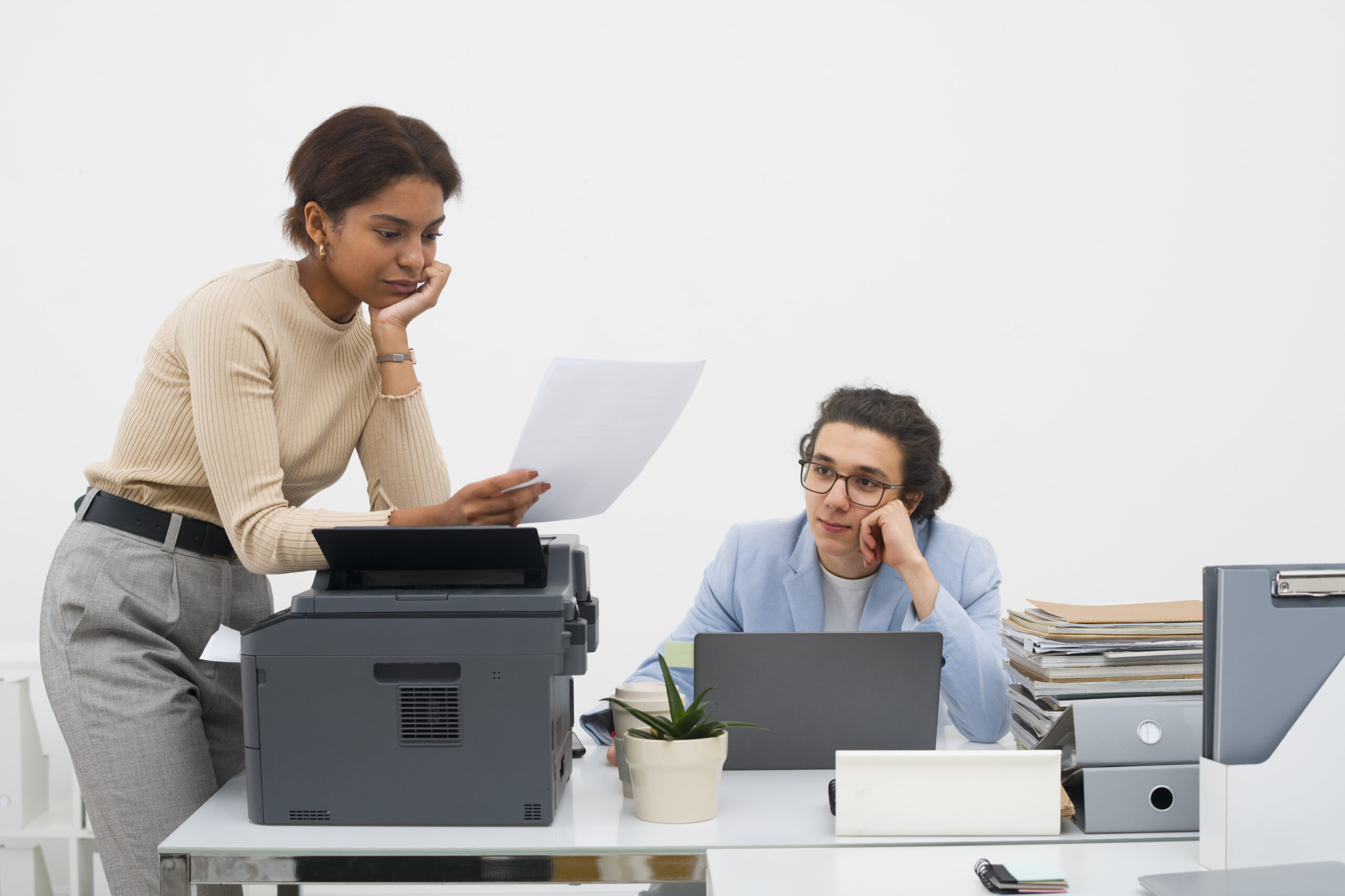 Colleagues looking frustrated while office scanner is not detected