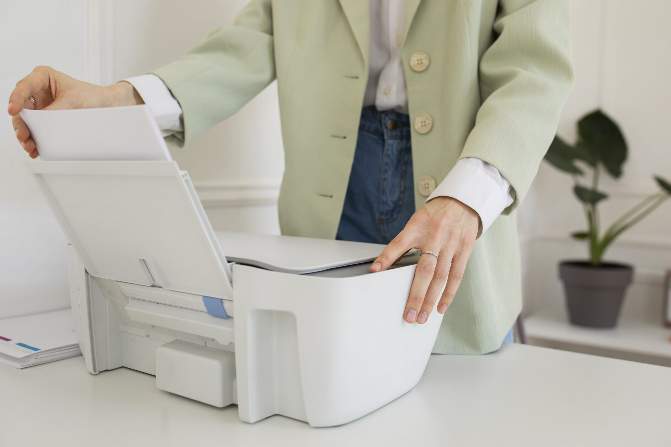 User performing a test scan on an office multifunction printer