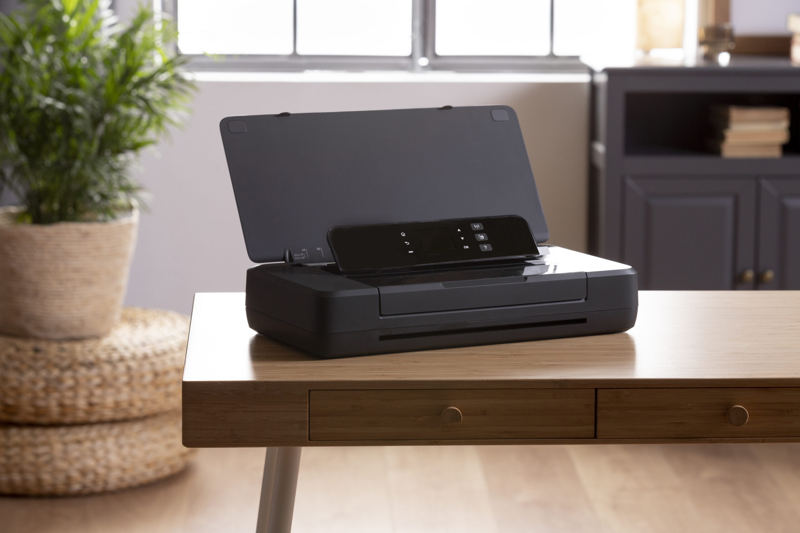 Home printer on desk with paper ready